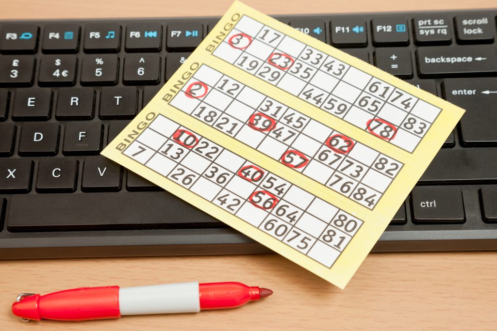 Image of Sample Bingo cards with red marker and computer keyboard